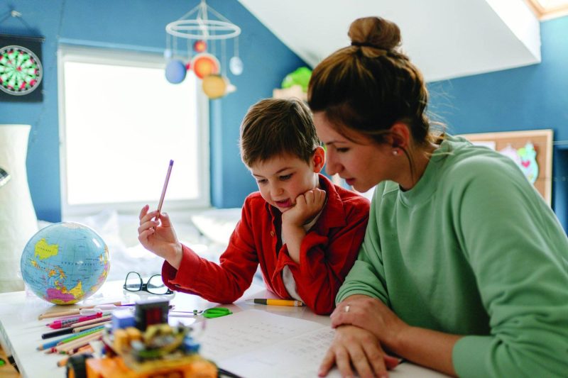 Mother and Son working on homework together - CharlottesvilleFamily