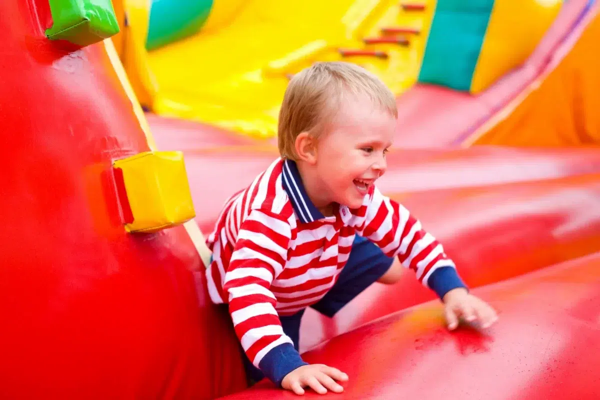 preschooler in a colorful bounce house indoor playgound
