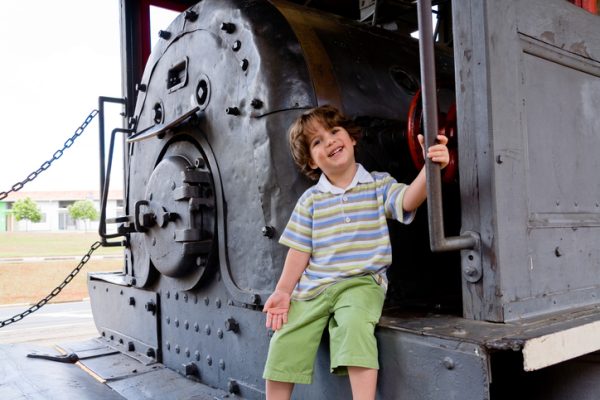 Child perched on the step of a vintage train in Virginia