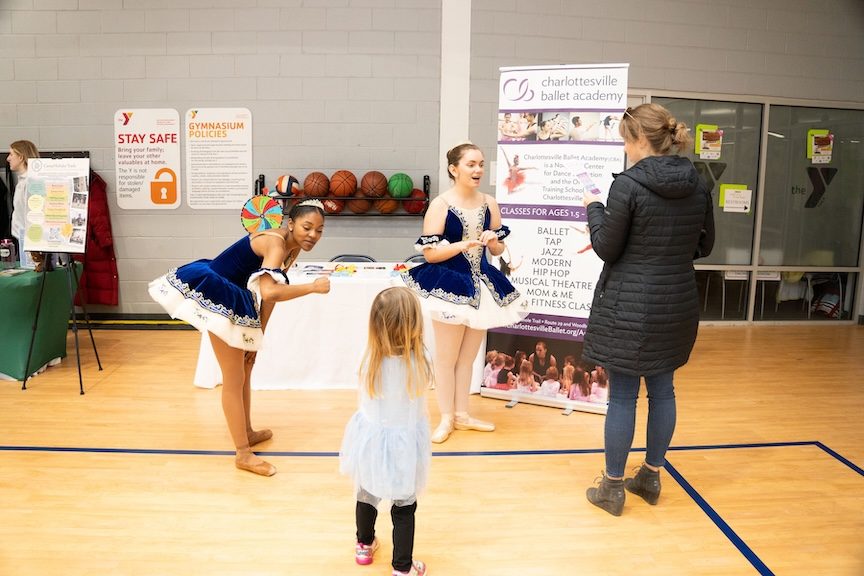 two ballerinas in blue and white tutus smile and talk to a parent and child at CharlottesvilleFamily Camp Expo and KidFest